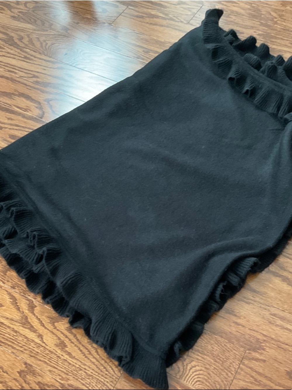 Black knit scarf with ruffle trim